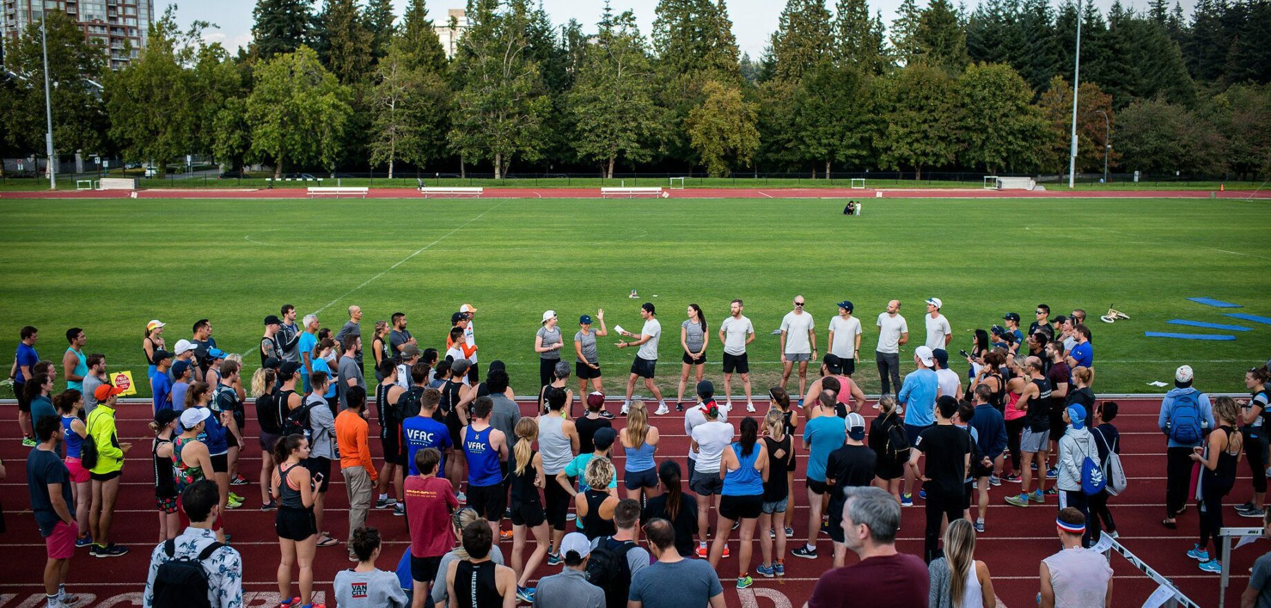 Photo of a runners gathered on the track at Chase The Pace IV with Mile2Marathon and Lululemon at UBC in Vancouver, BC.